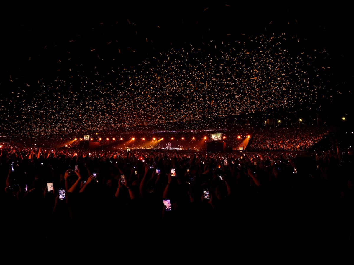 Crowd with phone lights and gold confetti